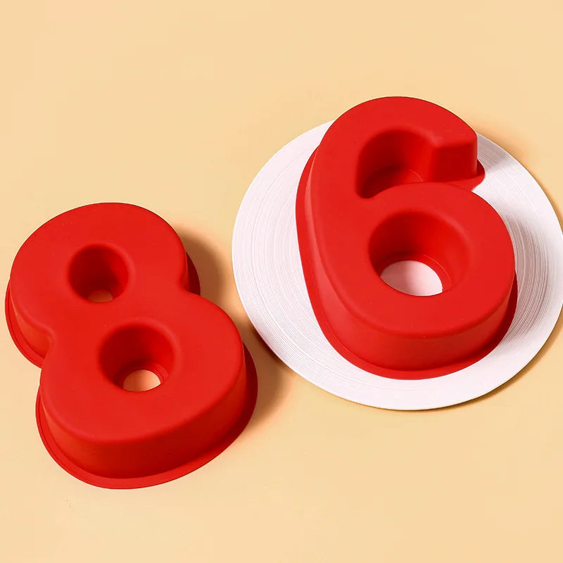 Red silicone cake molds shaped like the numbers 8 and 6 resting on a light background.