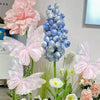 Pink and blue 3D simulated butterfly decorations displayed on a white background.