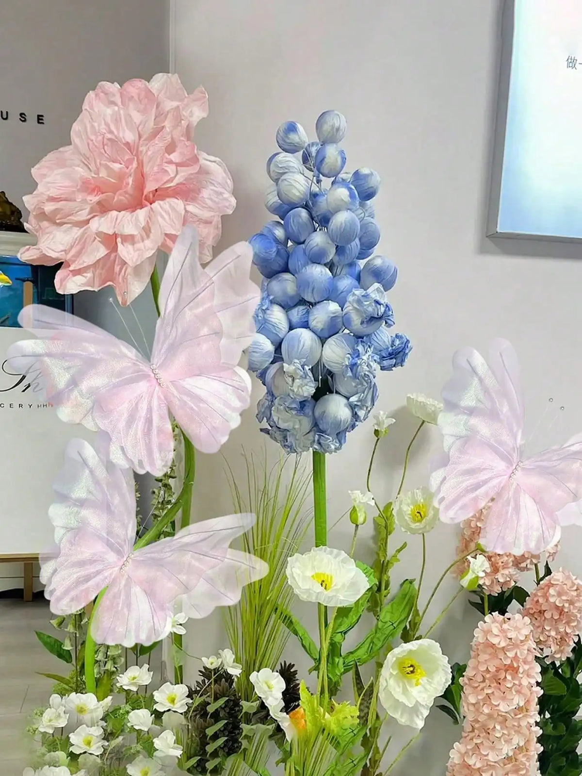Pink and blue 3D simulated butterfly decorations displayed on a white background.