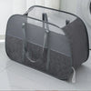 A gray mesh pop-up laundry basket is shown on a white floor next to a washing machine.