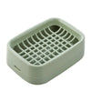 A light green double layer drain soap dish with a grid pattern for draining water.