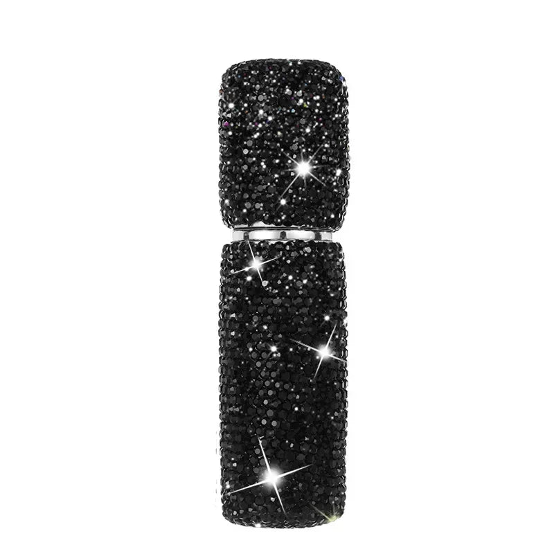 A vertical display of black glitter perfume spray bottles.