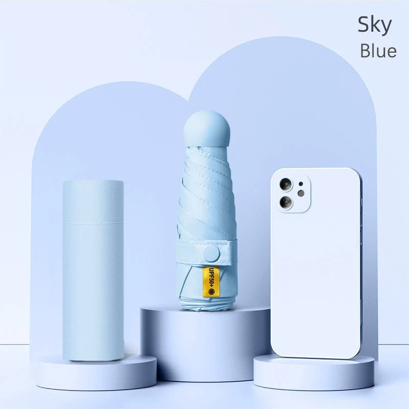 A light blue folding umbrella and a white smartphone are displayed against a soft blue background.