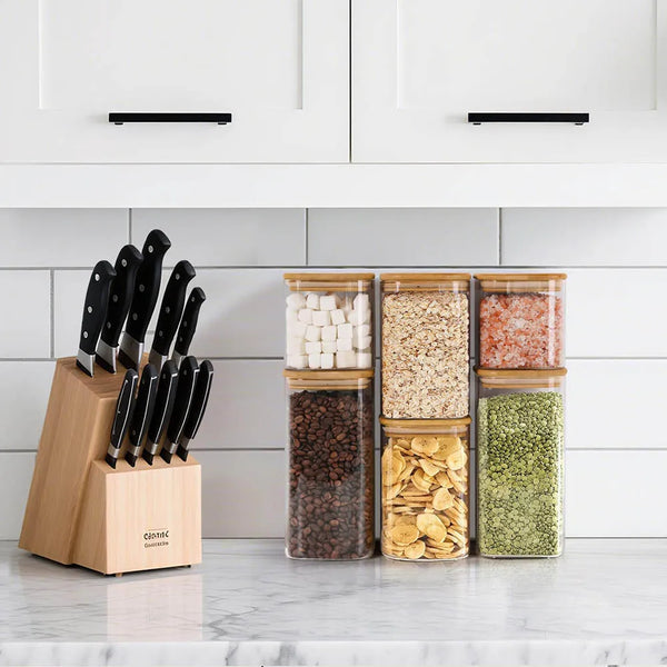 A collection of airtight glass storage canisters filled with various grains and seeds displayed on a kitchen counter.