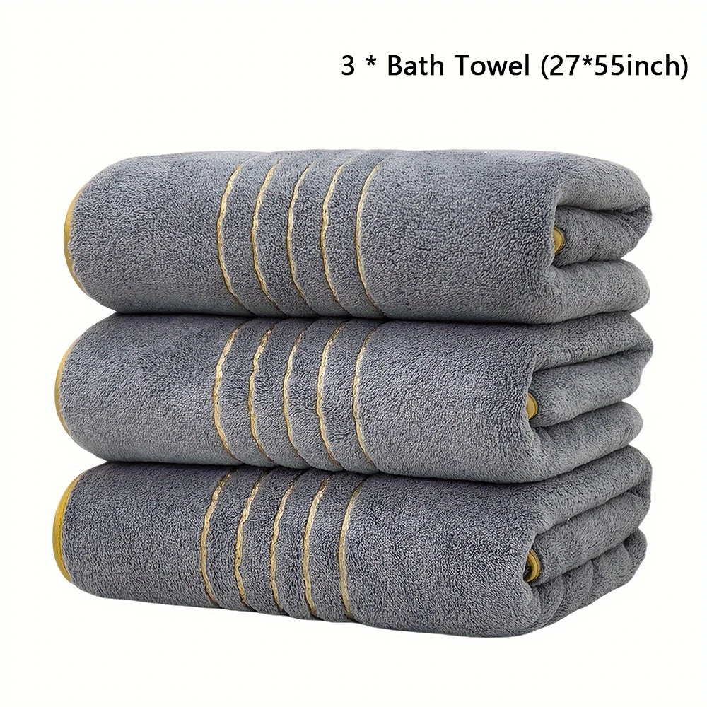 Three gray bath towels measuring 27 by 55 inches stacked neatly.