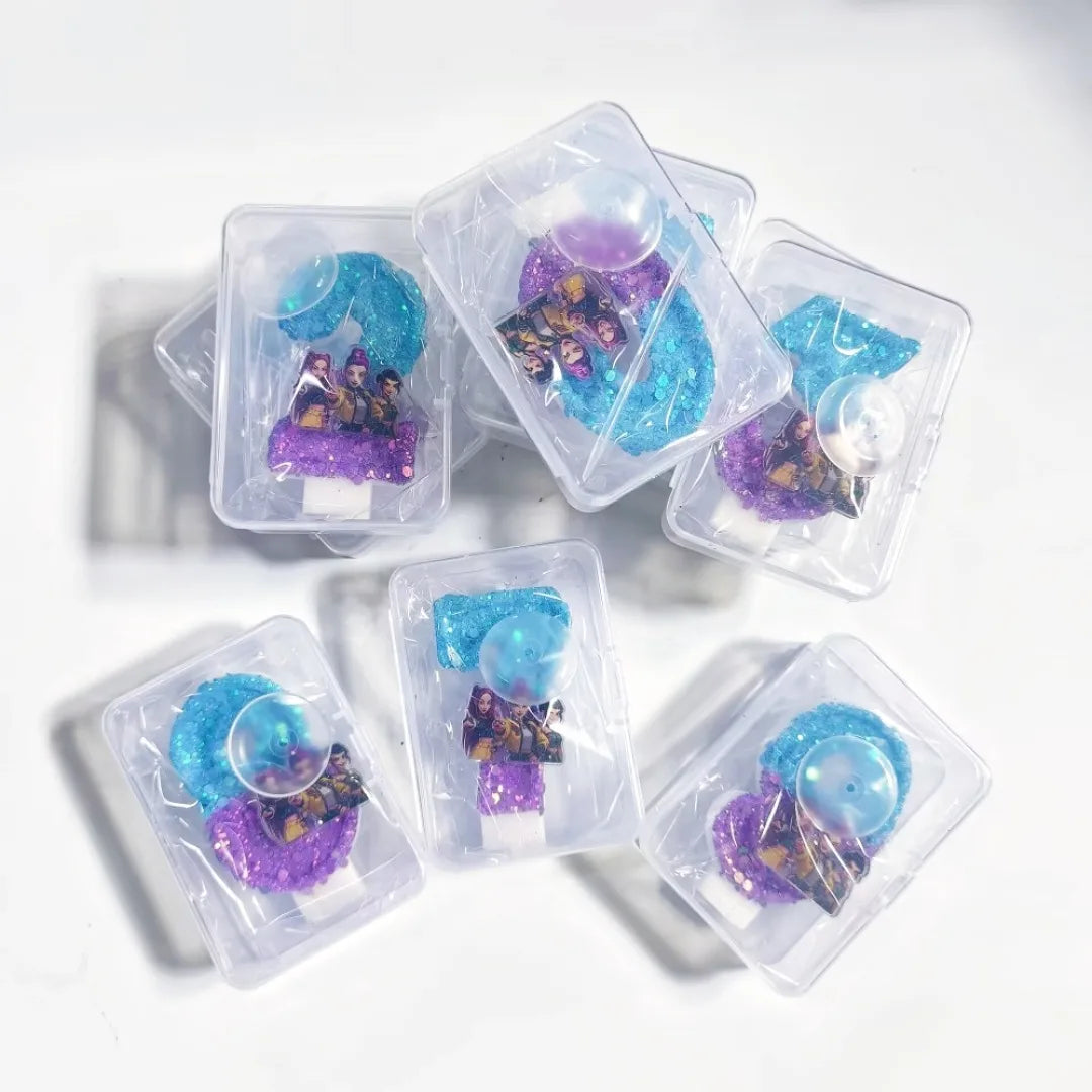 A collection of clear plastic containers filled with blue and purple candles for a birthday celebration.