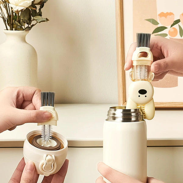 Hands hold a white bottle cleaning brush set and a white insulated cup.