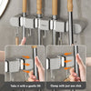 Wall mounted broom holder with a gentle lift and one-click clamp mechanism for kitchen or bathroom
