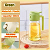 A clear plastic oil spray bottle with a green lid and handle, demonstrating dual-purpose pouring and spraying functions.