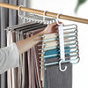 A hand hangs a light gray knitted sweater on a stainless steel multi-layer hanger rack.