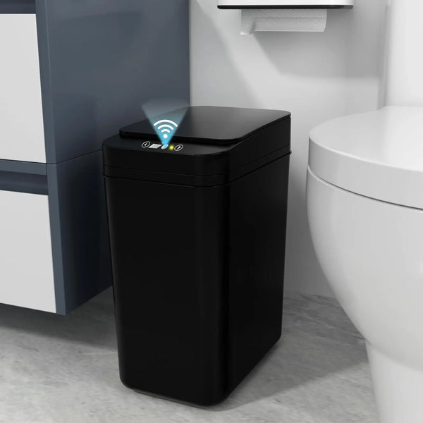 A black touchless automatic bathroom trash can with a sensor is placed next to a white toilet.