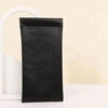 Black PU leather squeeze eyeglasses case with soft lining shown against a light background.