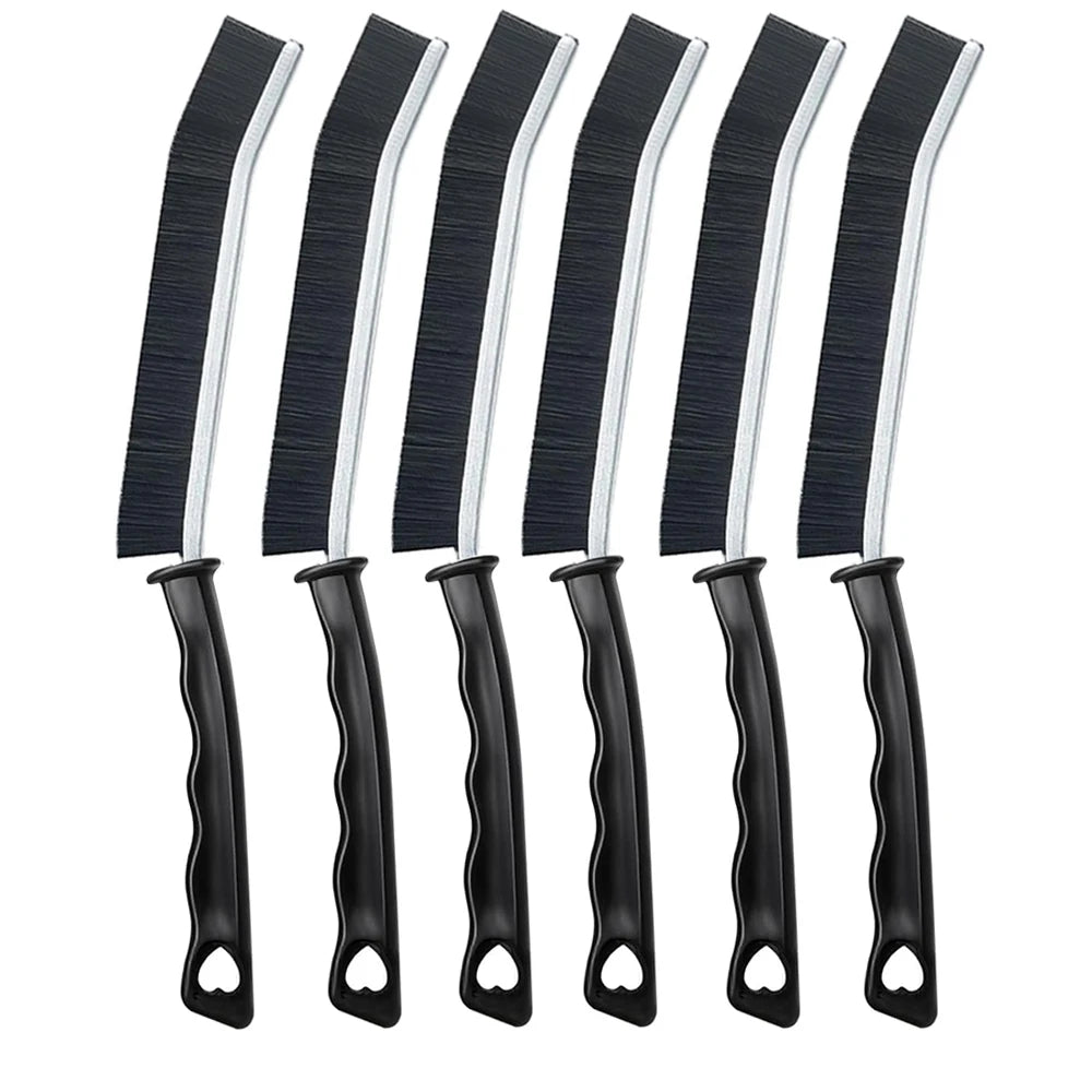 A set of black and white hard bristle crevice cleaning brushes for tight spaces