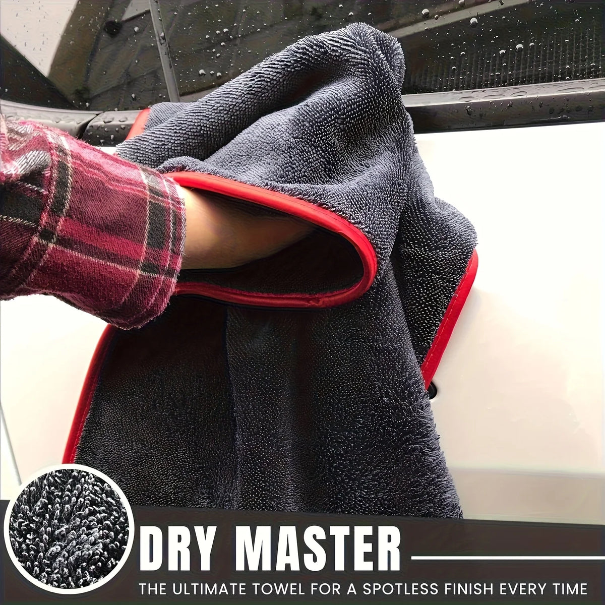 A dark gray microfiber towel is draped over a car, showing its texture and red trim.