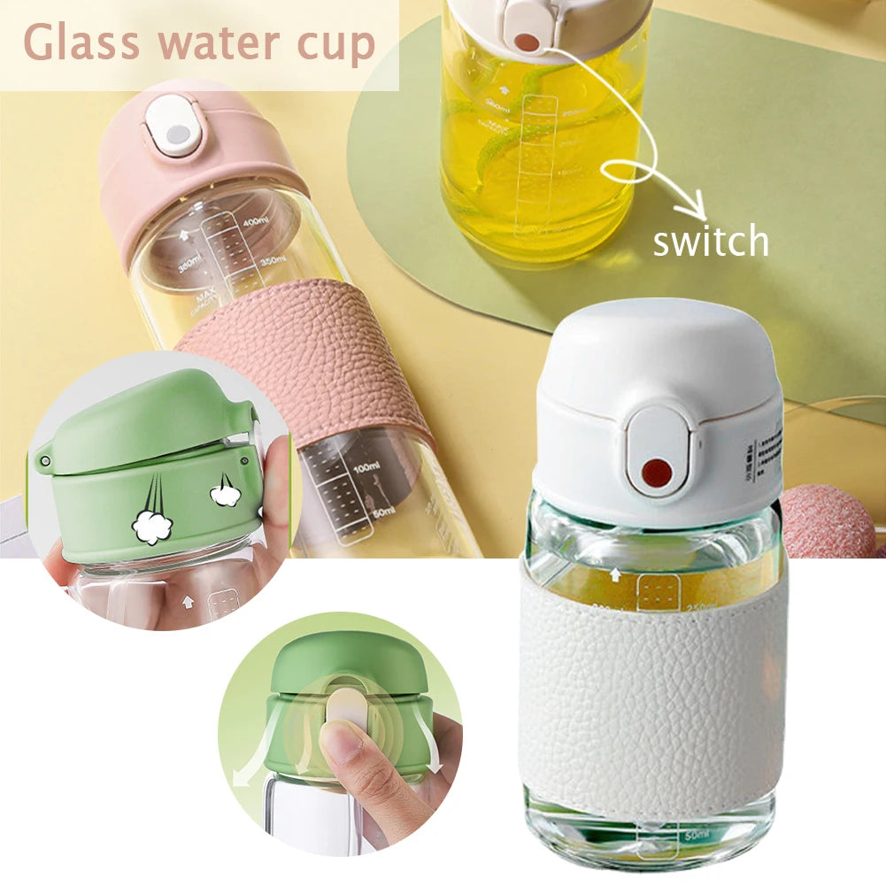 Un verre d'eau en verre avec un mécanisme à interrupteur et une balance, de couleur rose et blanc.