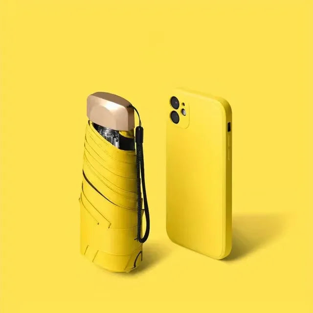 A yellow compact folding UV protection umbrella is shown against a plain yellow background.