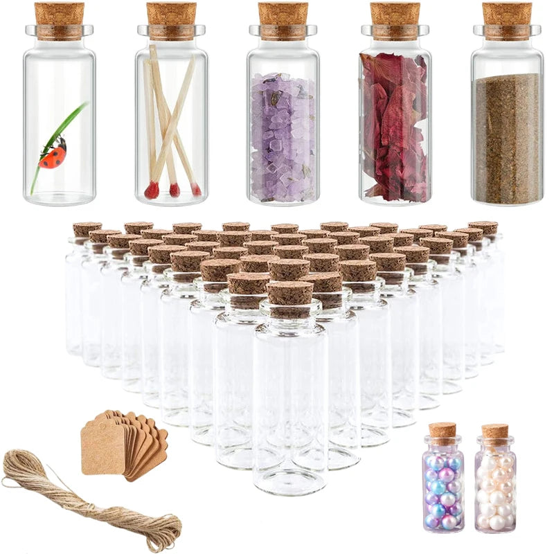 A set of ten mini glass bottles with corks containing various colored powders and natural elements for DIY art and gifts.