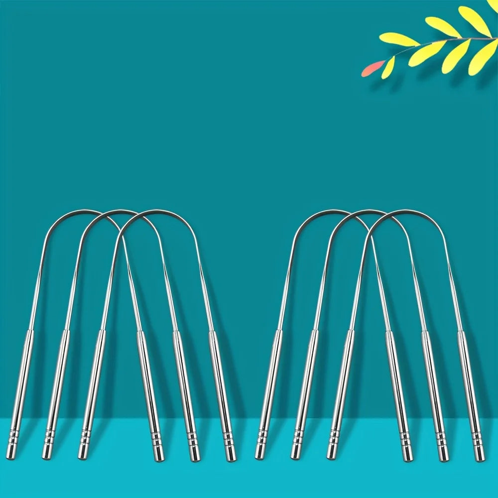 A set of stainless steel tongue scrapers displayed against a teal background.