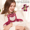 A woman is holding a pink cartoon plush toy, which is designed to be used as a hot water bottle.