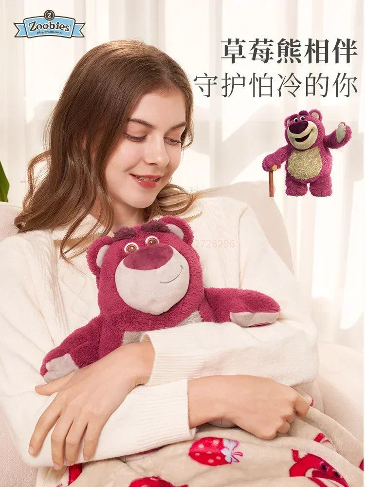 A woman is holding a pink cartoon plush toy, which is designed to be used as a hot water bottle.