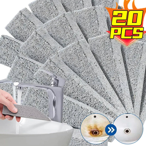 A hand uses a chemical-free pumice stone to remove a stain from a white ceramic surface.