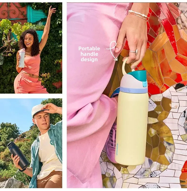 A close-up of a light yellow insulated water bottle with a teal lid and straw, held by a person wearing pink clothing.