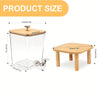 A clear glass and wooden laundry detergent dispenser with a stainless steel pump top and a wooden stand.
