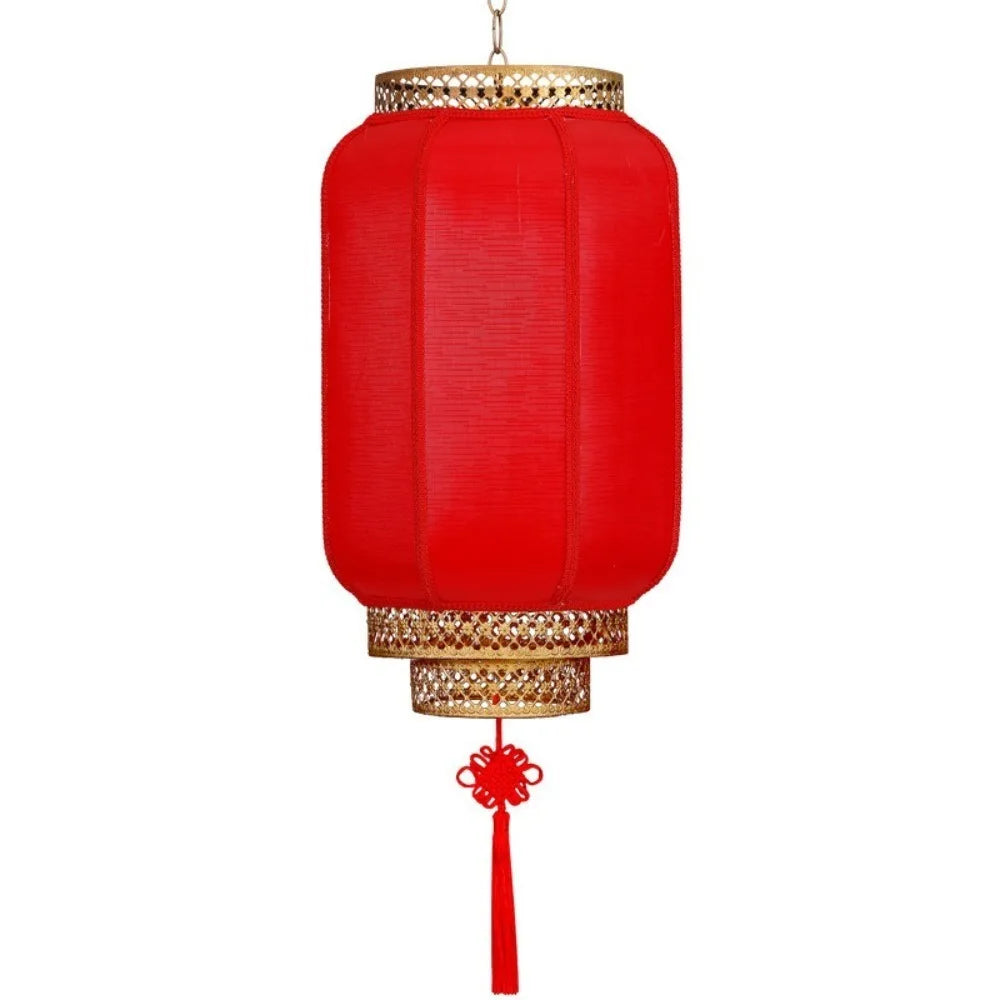 A durable antiqued red Chinese lantern with a gold rim and hanging tassel.