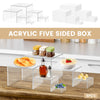 Six clear acrylic five-sided boxes stacked and used as a buffet riser for displaying food items