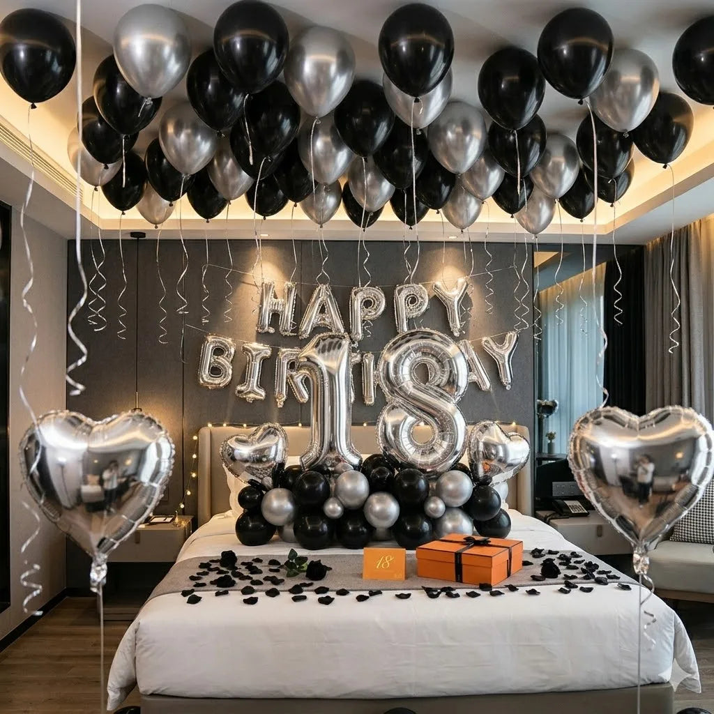 Elegant black and silver birthday decor featuring balloons and a heart-shaped balloon arrangement