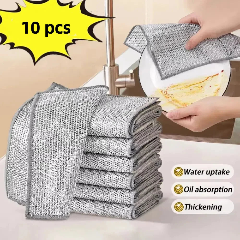 A set of ten gray non-stick wire cleaning dish rags being used to wipe a plate.