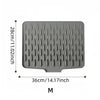 Gray silicone drain mat with a perforated surface measuring 28cm by 36cm.