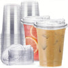 A stack of clear reusable disposable coffee cups with lids and a tall glass filled with iced coffee.
