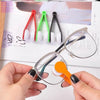 A hand holds a pair of eyeglasses with an orange cleaning brush and white bristles, next to a set of green and red microfiber