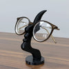 A black minimalist 3D printed profile stand for eyeglasses.