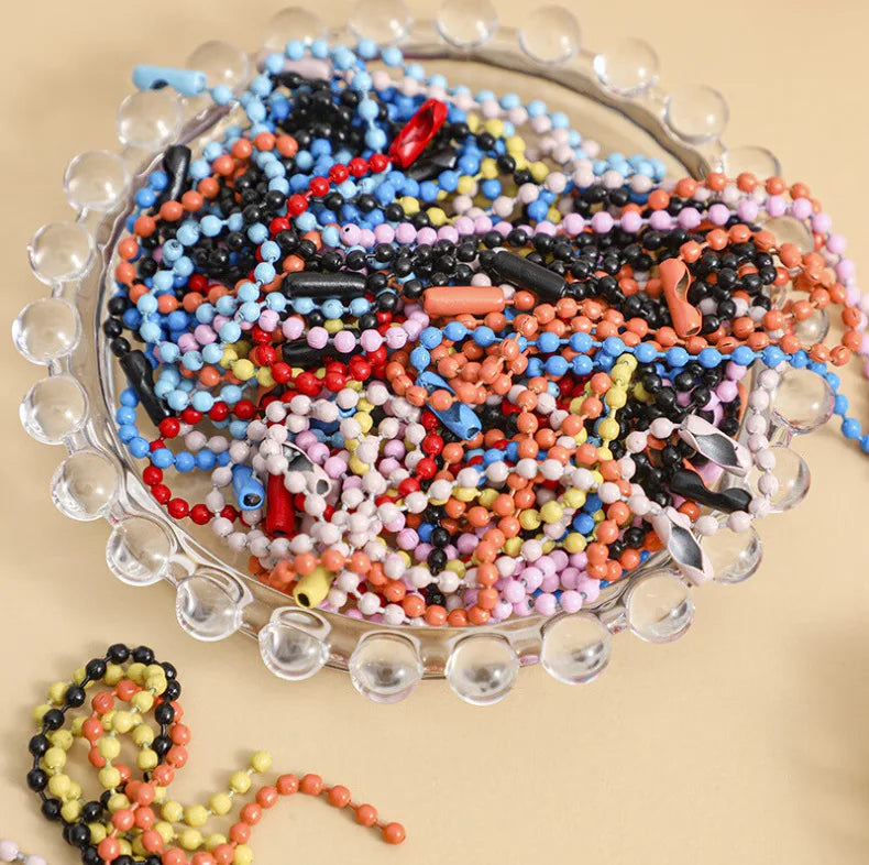 A glass dish filled with a colorful assortment of tiny beads and stringing materials for crafting and decoration