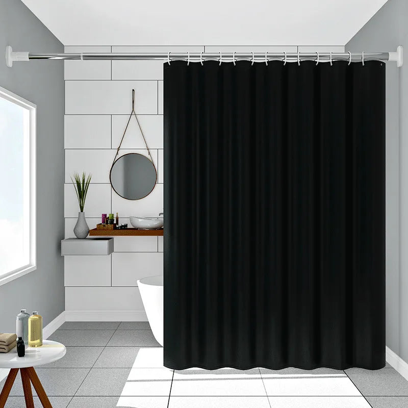 Pure black decorative shower curtain hanging on a rod in a bathroom setting.