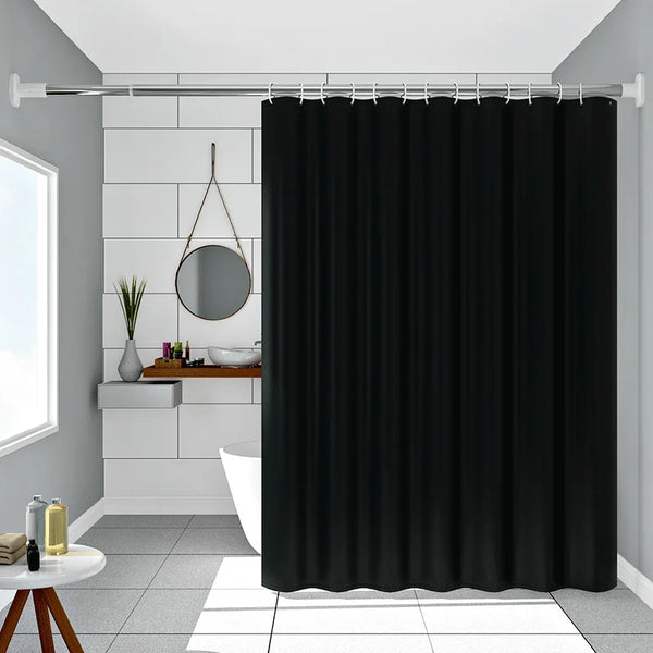 Pure black decorative shower curtain hanging on a rod in a bathroom setting.