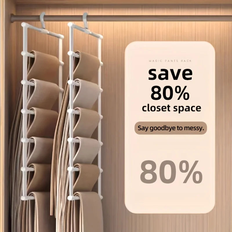 A multi-layer stainless steel pants rack with beige pants hanging on a wooden rod.