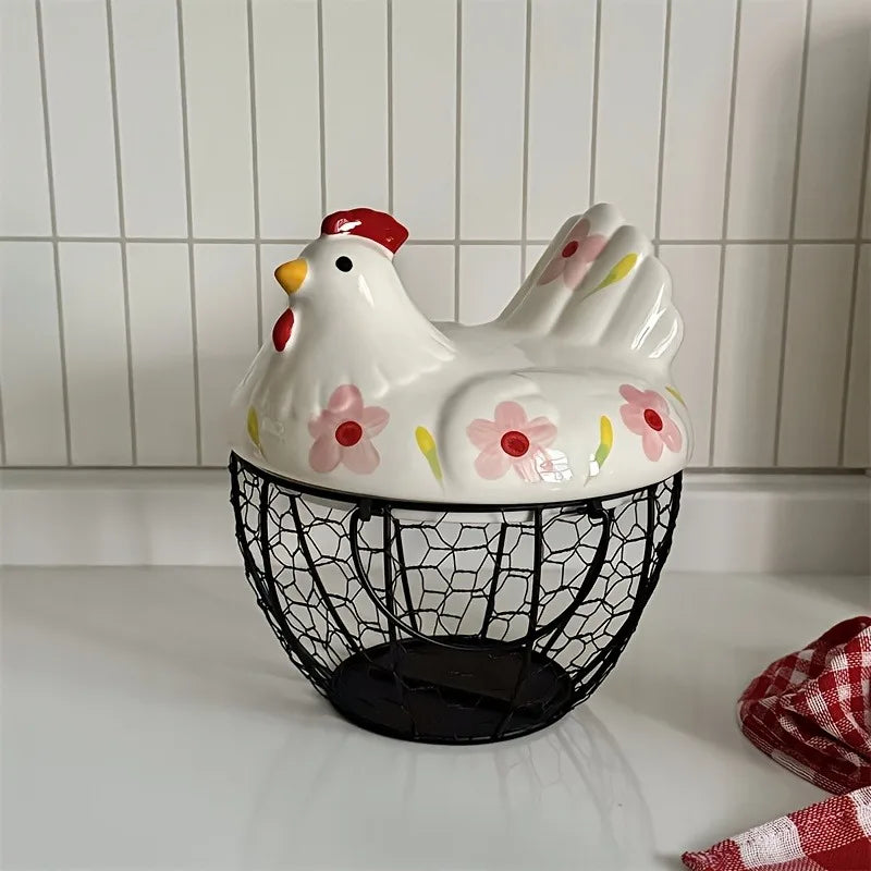 A white ceramic hen-shaped fruit basket with a red comb and yellow accents, displayed against a white tiled background.