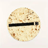 A round tortilla or flatbread with a unique, speckled design, featuring a black leather strap and silver buckle.