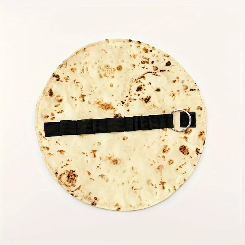 A round tortilla or flatbread with a unique, speckled design, featuring a black leather strap and silver buckle.