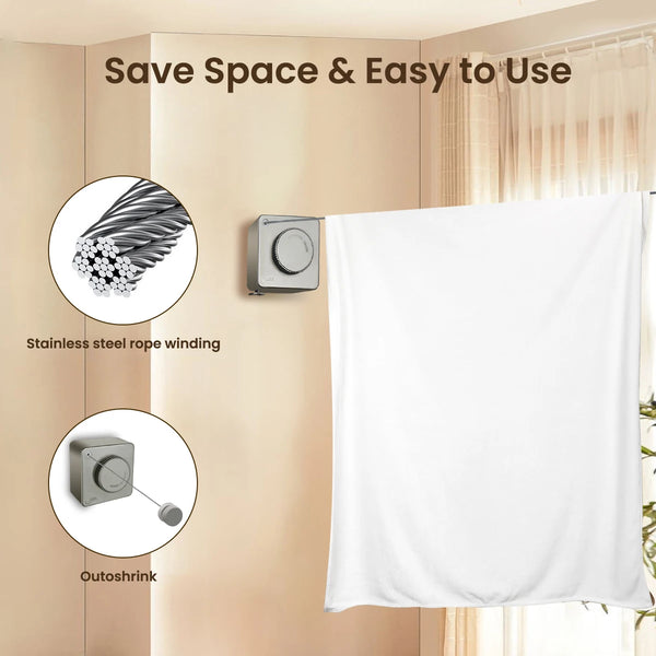 A white fabric is hanging from a retractable stainless steel rope wind line against a light-colored wall.