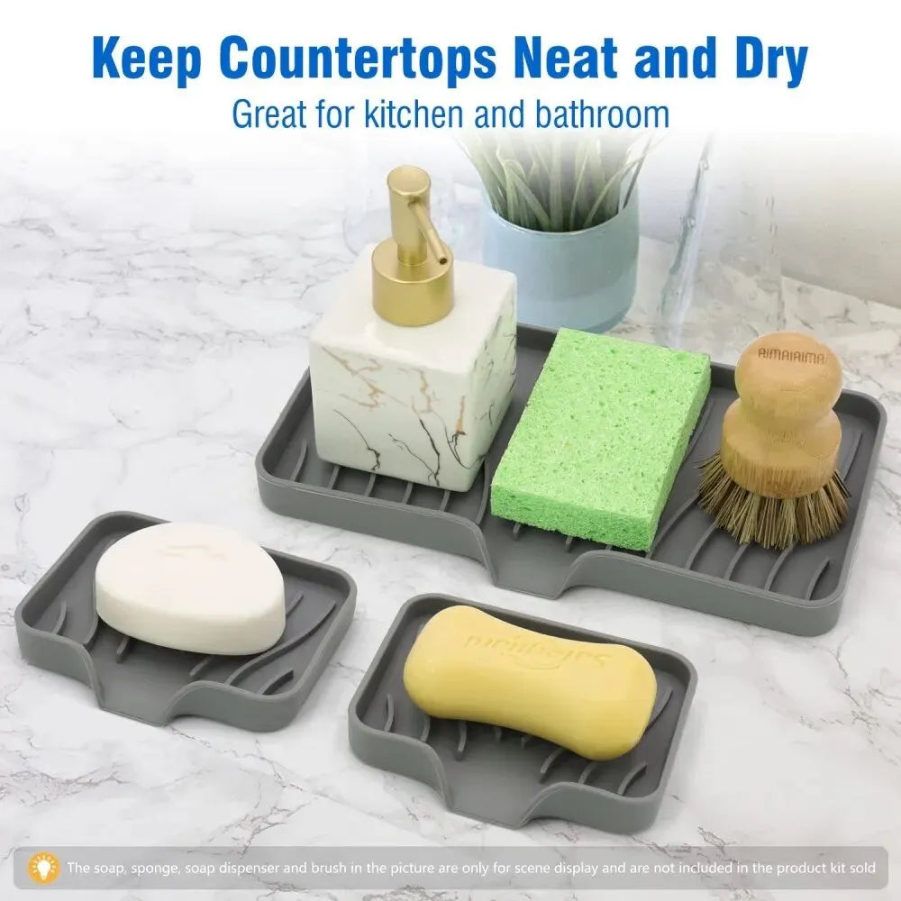 Silicone draining soap tray organizer with a yellow bar soap and green sponge on a marble surface.