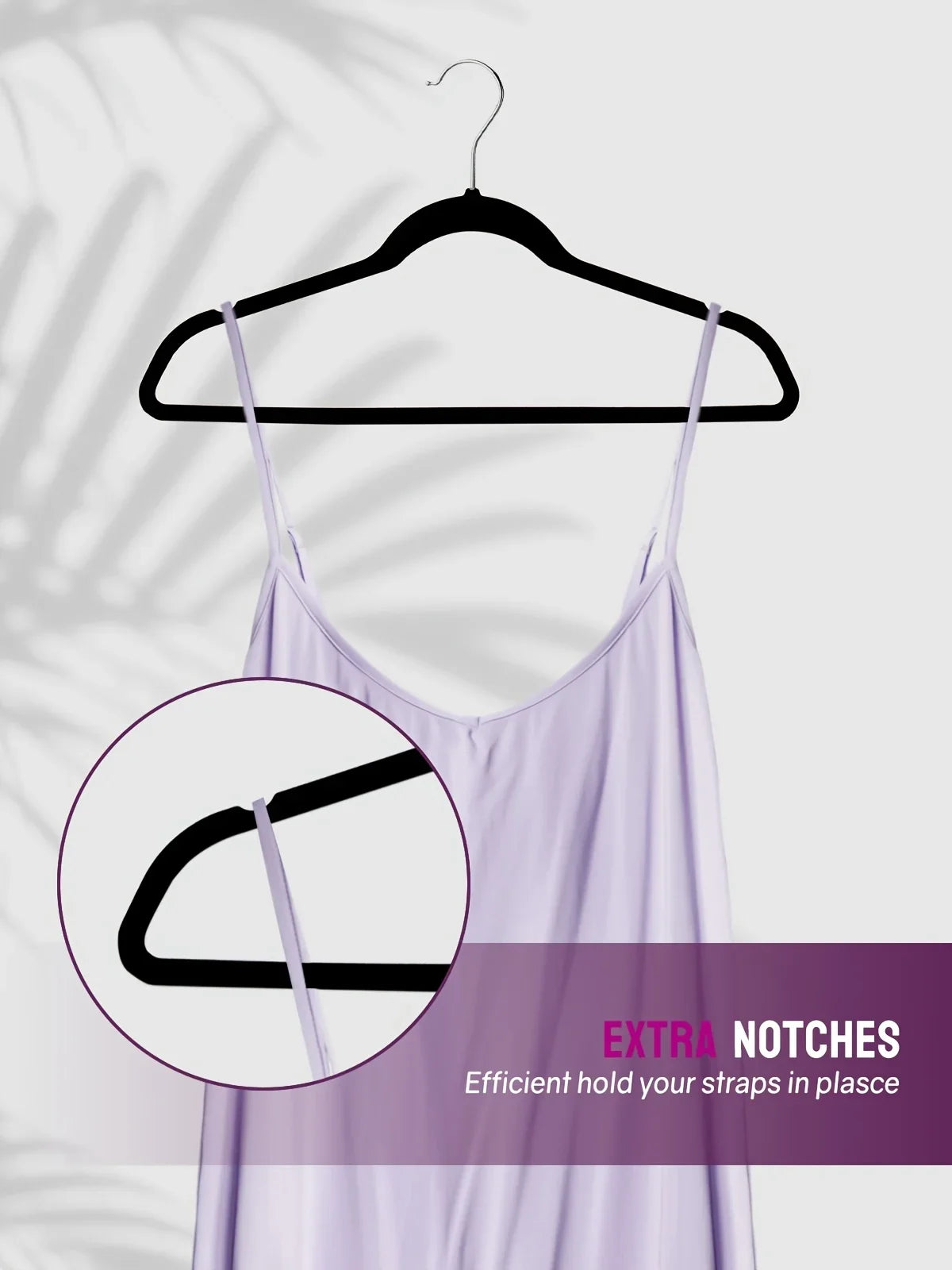 A lavender slip dress is hanging on a black hanger, demonstrating extra notches for secure strap placement.