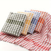 A stack of absorbent cotton cleaning cloths in various plaid patterns, including green, yellow, blue, and red.