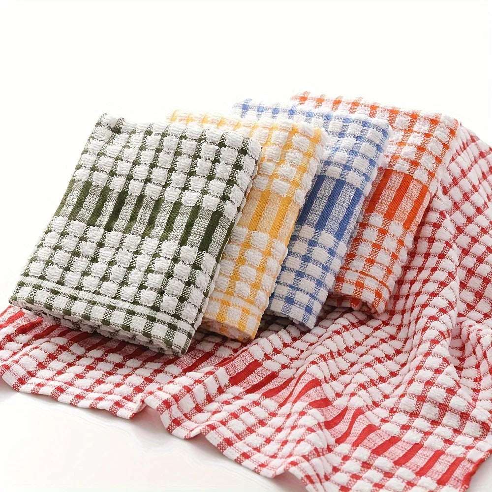 A stack of absorbent cotton cleaning cloths in various plaid patterns, including green, yellow, blue, and red.