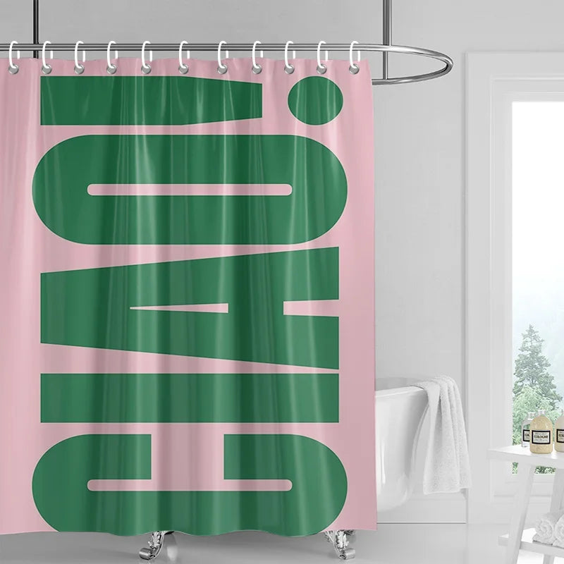 A pink and green abstract geometric art shower curtain hanging on a metal rod.