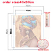 A canvas print featuring a woman's profile in a colorful turban and jewelry, displayed with size dimensions.