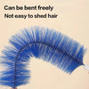 A close-up of a blue bristled brush being bent freely and used for cleaning.